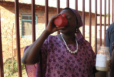 Regina Majaliwa drinking from a mug.