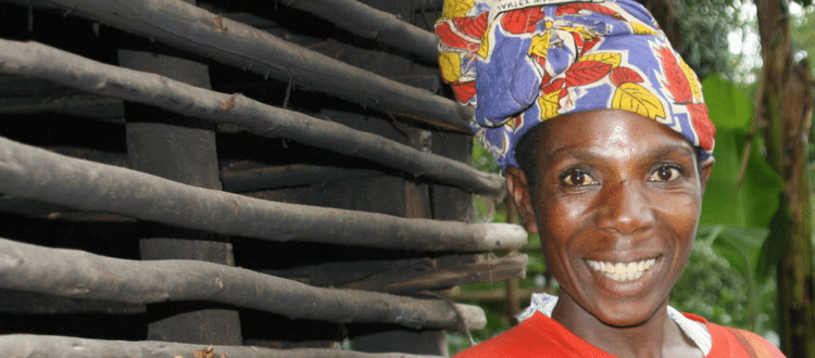 Woman wearing colorful hat and smiling.