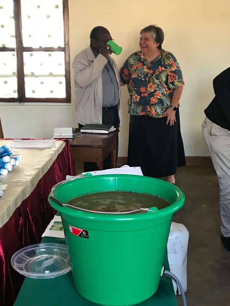 Bishop Kaggwa drinking clean filtered water.