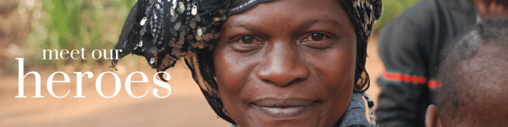 Woman smiling outside. Text says, "Meet our heroes."