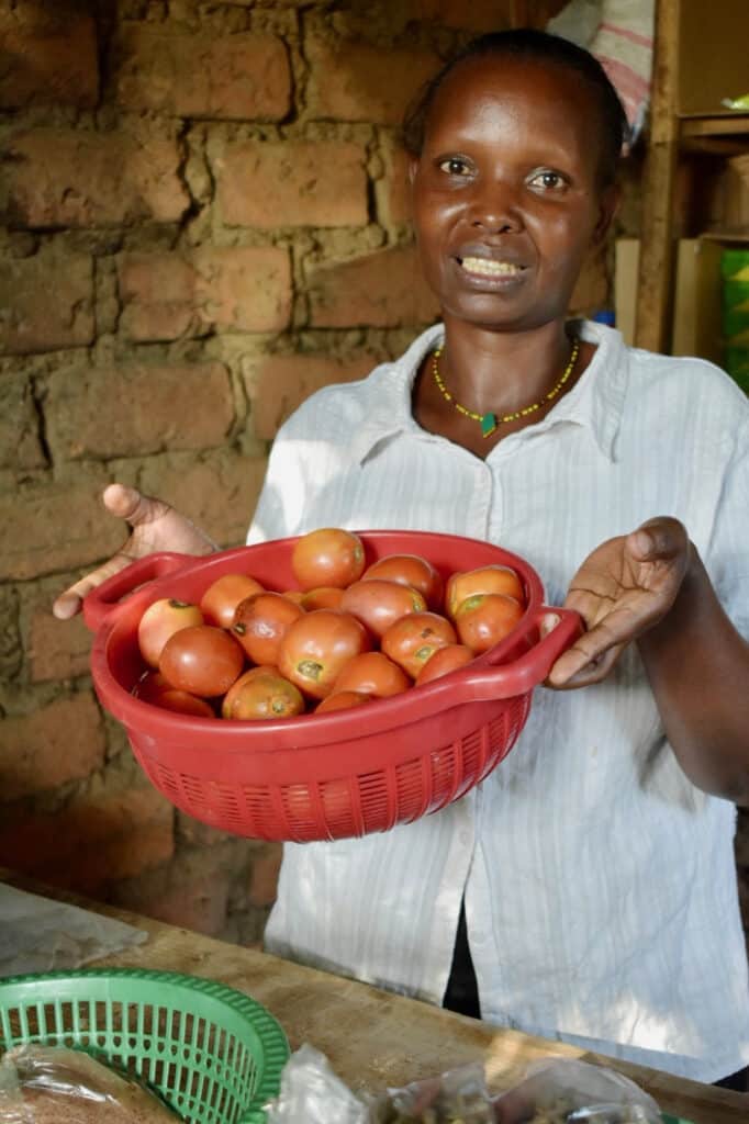 Woman holding a bowl of tomatoes.