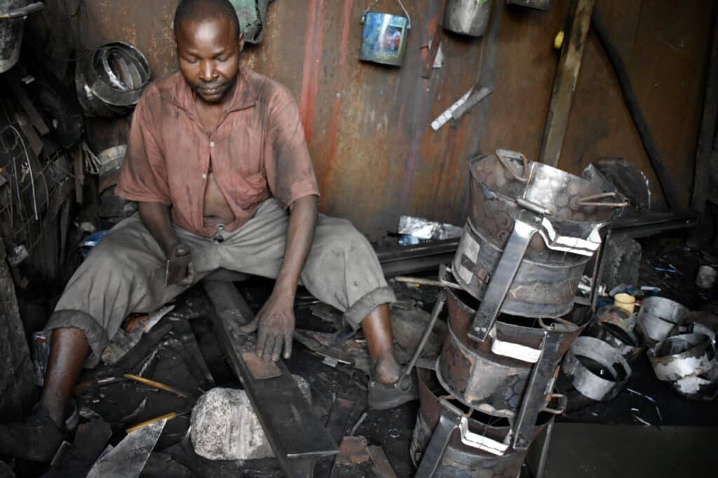 In Kenya, a member of Jamii Bora in his shop working to recycle metal to create rakes, shovels, pots and more. 