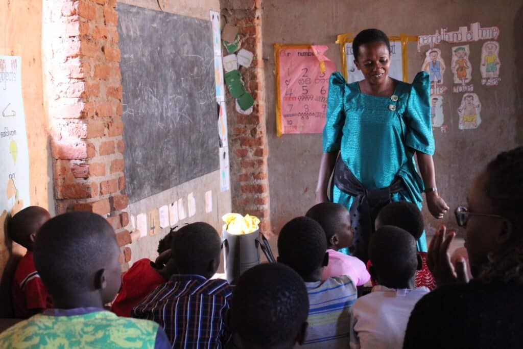 A school teacher instructing a classroom full of young children.