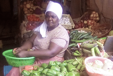 Annah Wanyaga working at a vegetable stand.