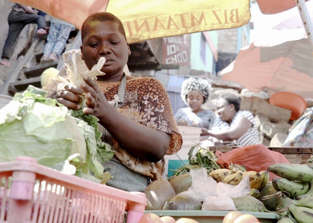 Woman working at market stand.