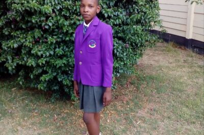 Cynthia - Shalom standing outside wearing her school uniform.