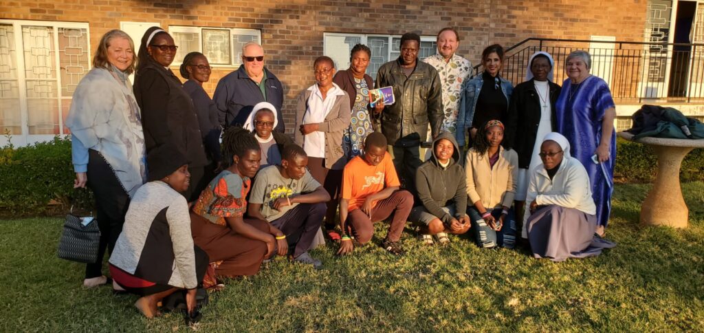 A group of people outdoors smiling at the camera.