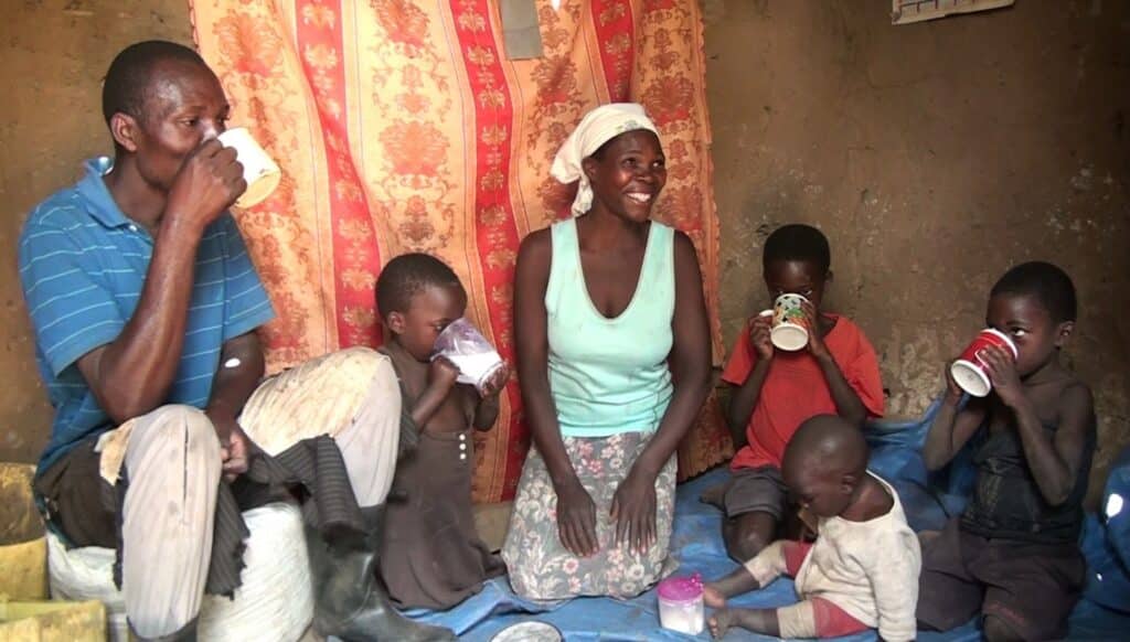 A man and woman with four children at mealtime.
